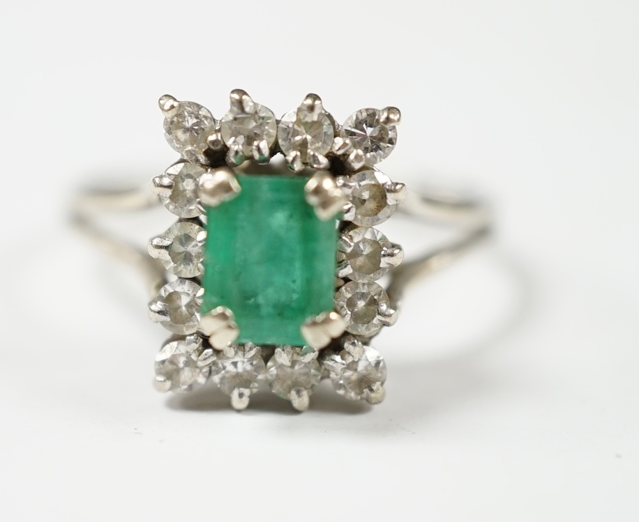 A 1960's white gold?, emerald and diamond set rectangular cluster ring, size T/S, gross weight 4.3 grams. Condition - poor